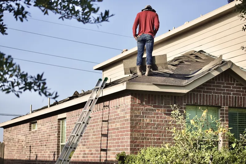Professional roofer working on a residential roof in Matoaka